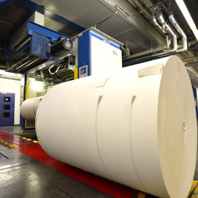 paper roll for printing in front of a web offset printing machin