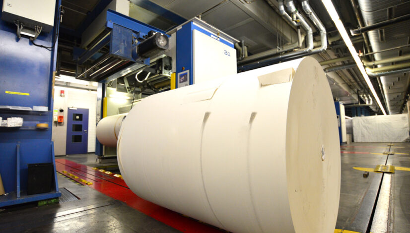 paper roll for printing in front of a web offset printing machin