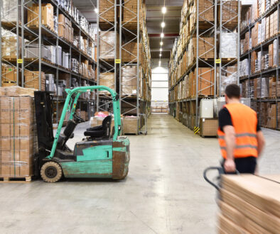 warehouse worker in a forwarding agency - interior with forklift
