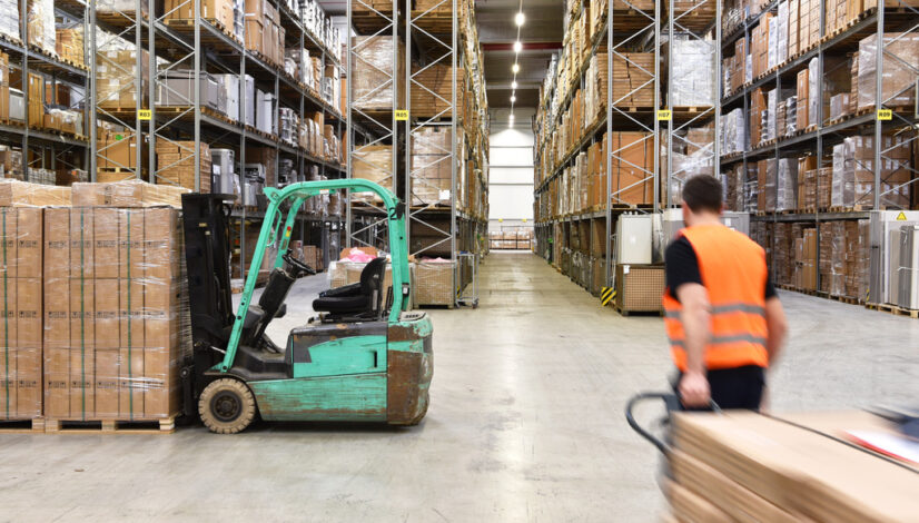 warehouse worker in a forwarding agency - interior with forklift